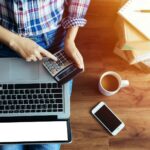 10 métodos de fijación de precios | Asignación de precios estratégica Mujer sentada en el suelo analizando cuál de los métodos de fijación de precios utilizar