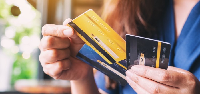 Una mujer sosteniendo tarjetas de crédito